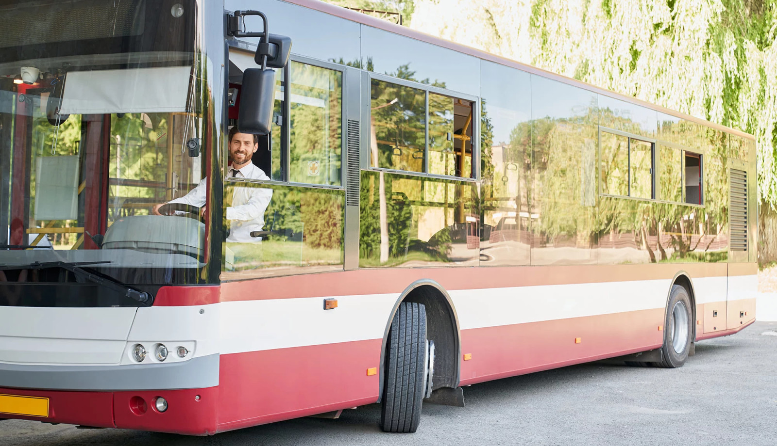 media.elegant-driver-sitting-shuttle-bus-smiling-camera-summer-day-front-view-happy-man